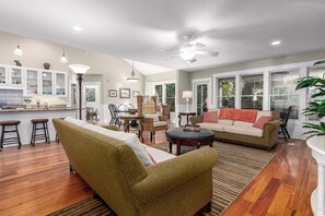 Relax in this open-plan living area with a sofa set, dining table, and kitchen area.