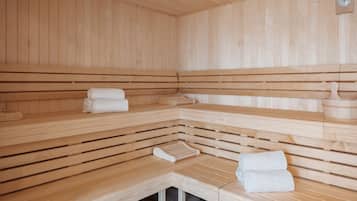 A sauna with wooden benches and benches, towels, and a wooden bench with a bench seat.