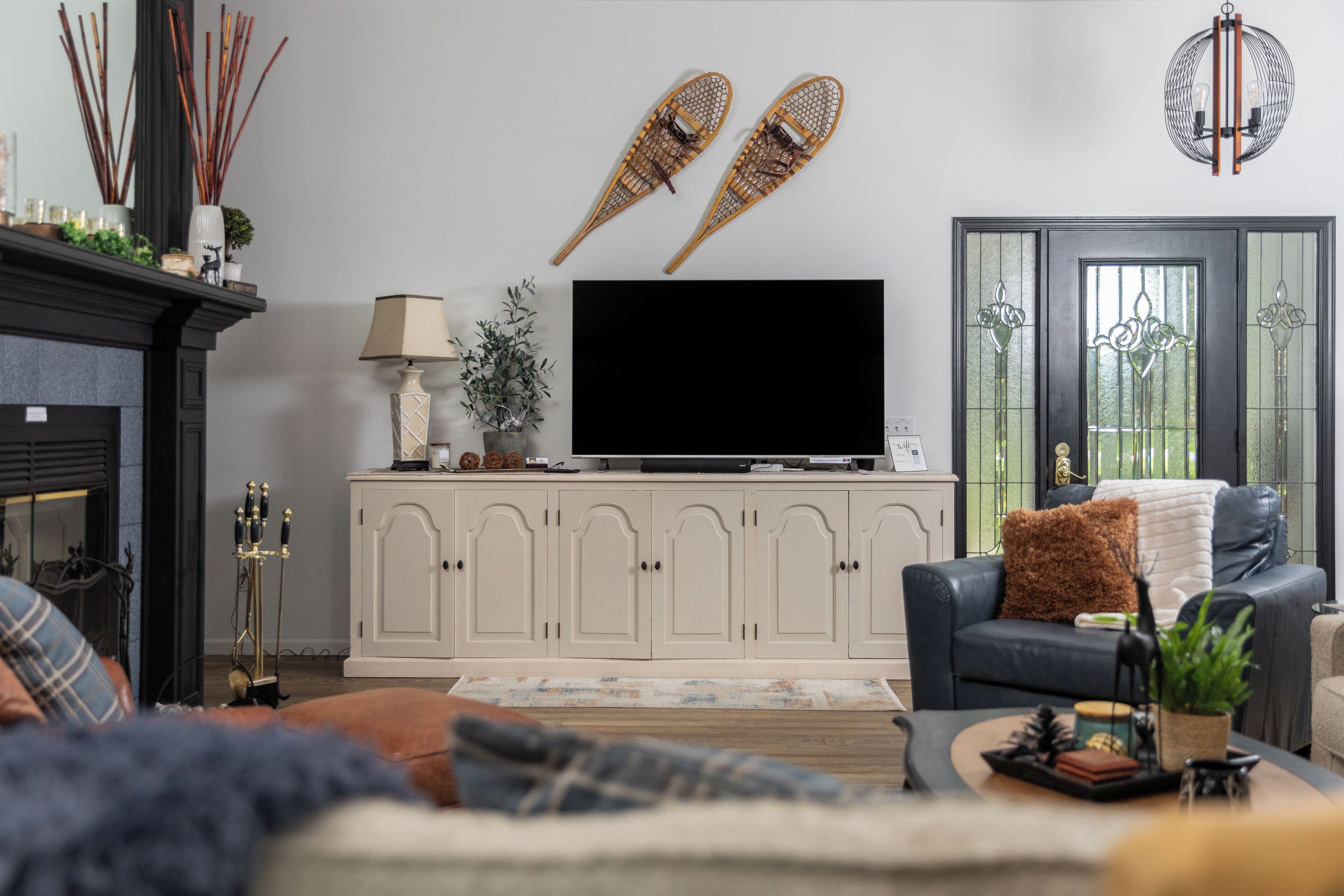 A living room with a fireplace, a television on a cabinet, a sofa, and a coffee table.