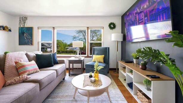 A modern living room with a sofa, armchair, coffee table, and a large painting on the wall. - Curated for Cozy Stays -2 Parking Spaces, Sleeps 4 (Westmont)
