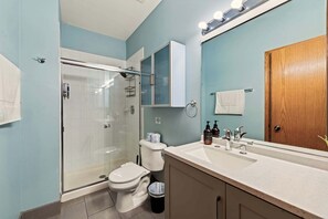 Bathtub, hair dryer, towels, shampoo