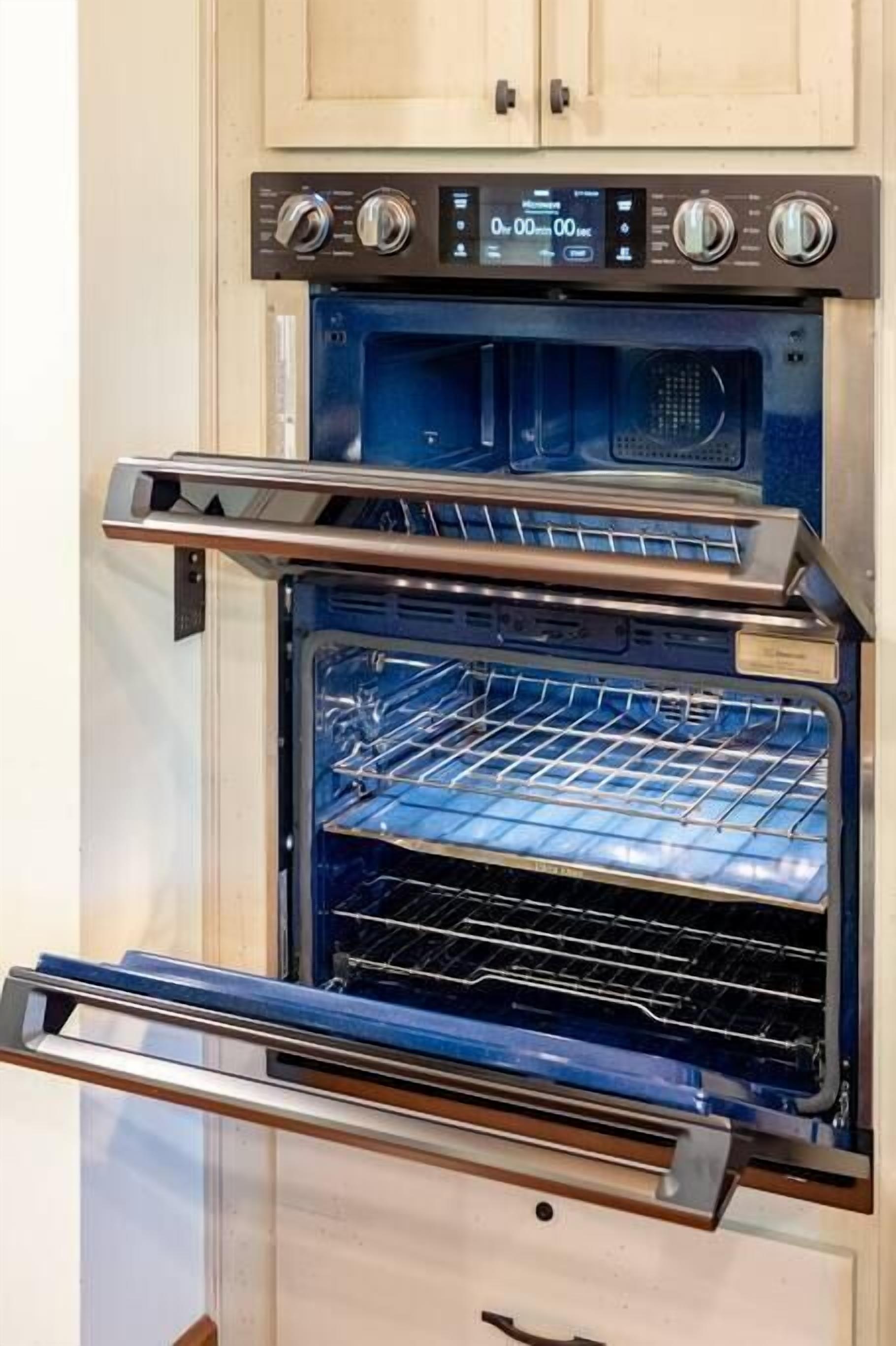 A kitchen with an integrated oven and microwave.