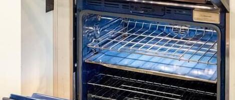 A kitchen with an integrated oven and microwave.
