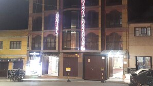 Un hôtel avec une enseigne bien visible indiquant « HÔTEL CASA GRANDE » et une entrée facilement identifiable.