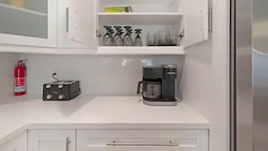 A kitchen with a white countertop, a coffee maker, a toaster, and a fire extinguisher. - Peaceful Retreat  3 Bedroom  10 min to WEC (Marion County)
