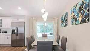 A modern kitchen with white cabinets and a stainless steel refrigerator. - Peaceful Retreat  3 Bedroom  10 min to WEC (Marion County)