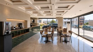 A modern hotel lobby with a bar area, seating, and large windows offering a view of the street. - Nora Airport Hotel Istanbul  (Arnavutköy)