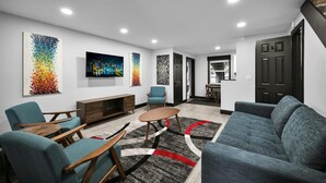 A modern living room with a sofa, chairs, a coffee table, and artwork on the walls. - Escape to This Gorgeous new Wilton Manors Villa (Wilton Manors)