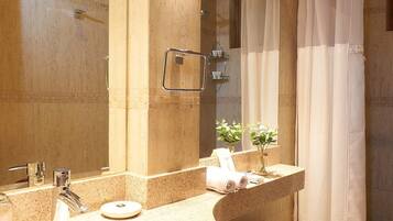 A bathroom with a sink, toilet, and shower curtain.