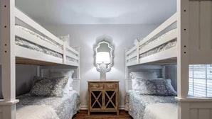 A room with bunk beds, a wooden nightstand, and a wall-mounted mirror. - 5 Bdrm, Amazing Sunsets, deck, flat yard, dock, fish, beach, kayaks... (Sparta)