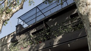 A building with two windows, a door, and a balcony with a metal railing. - PH Palermo Hostel (Buenos Aires)