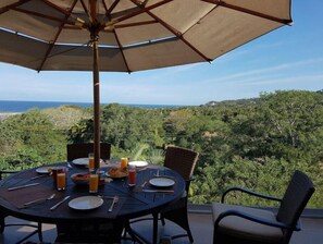 Enjoy a romantic meal for two under the shade of a large umbrella, overlooking the serene ocean views.