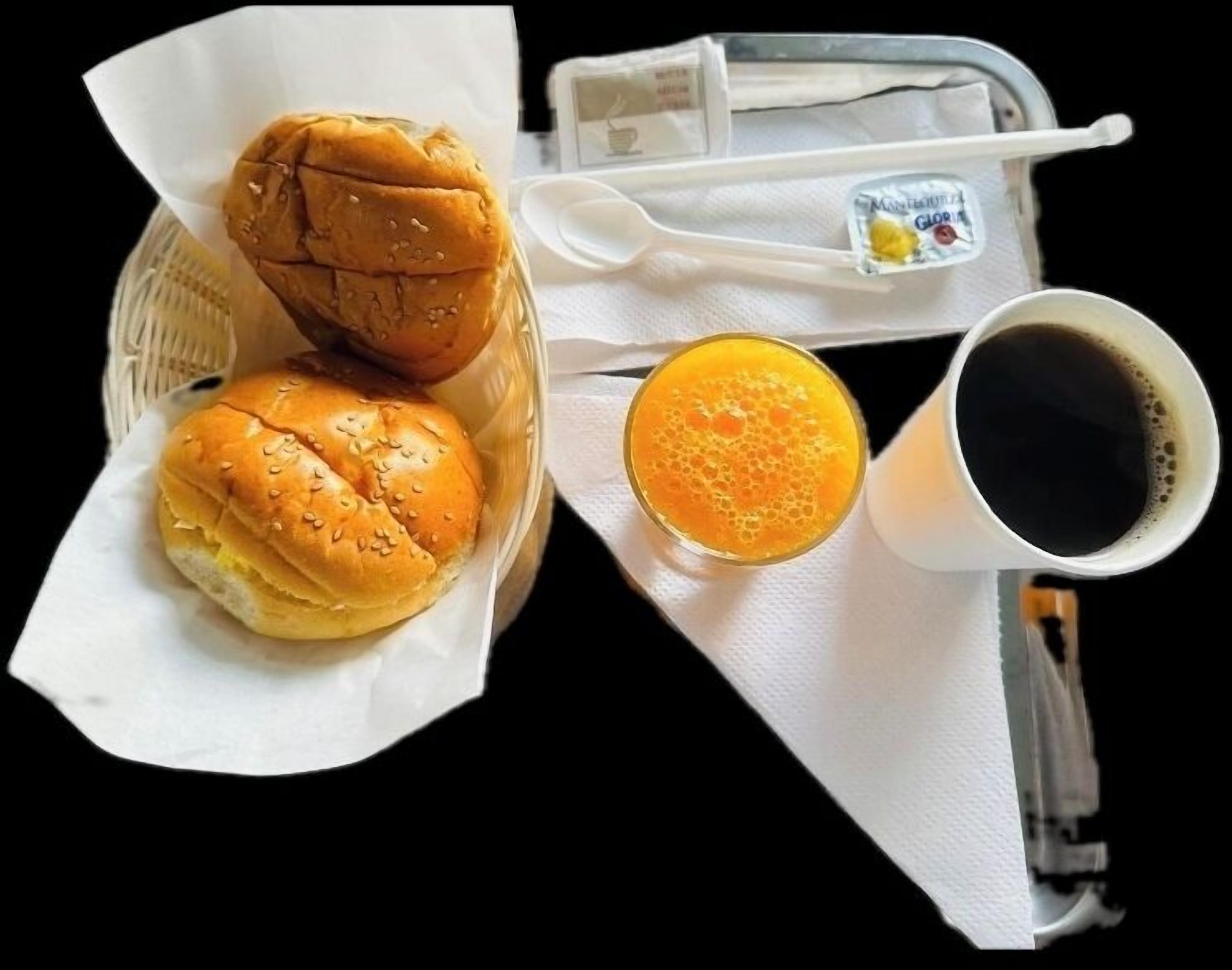 A tray with two sandwiches, a glass of orange juice, and a cup of black coffee.