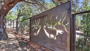 A metal fence with a silhouette of a horse and a dog. - Wandering Pines - Scenic and peaceful getaway (Pine)