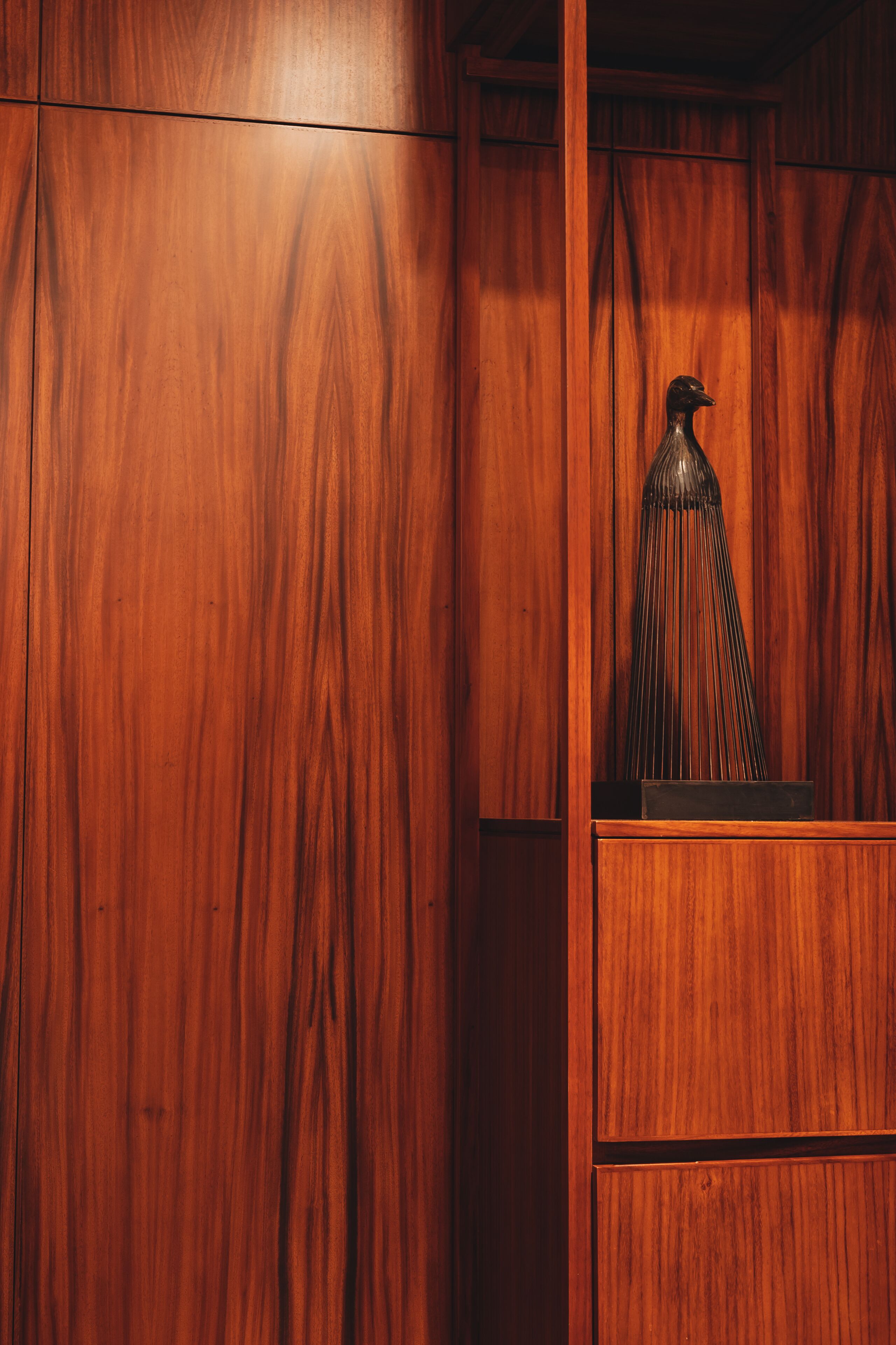 A wooden cabinet with a decorative object inside.