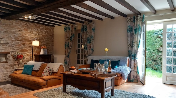 Relax in this inviting living room with a comfortable sofa, armchair, and fireplace.