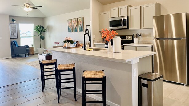 A modern kitchen with a central island, stainless steel appliances, and a seating area with stools. - Cozy home # Safe Neighborhood & Pet Friendly (Lubbock)