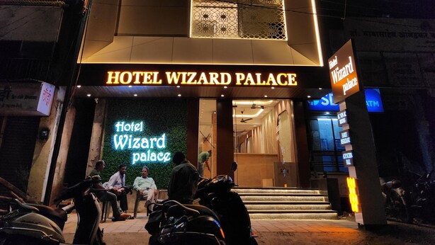The exterior of Hotel Wizard Palace with illuminated signage and a modern facade.