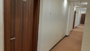 A corridor with wooden doors, each marked with a number.