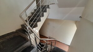 A staircase with metal railings leading to a landing.