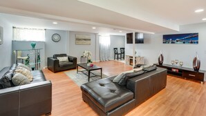 A modern living room with a sofa set, a coffee table, and a fireplace. - Cozy Albany Vacation Rental ~ 5 Mi to Downtown! (Albany)