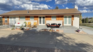 A two-story house with a front porch, a garage, and a driveway.