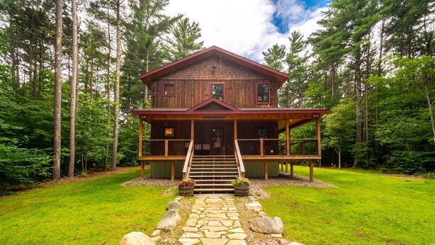 A wooden cabin with a porch, stone pathway, and a staircase leading to the entrance. - Large, Luxury, Views, Near Whiteface, Lake Placid (Wilmington)