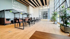 A modern office space with a large open area, wooden flooring, and a wall with the text "Let's work together". - 26th Floor A/C, Pool & Coworking (Medellín)