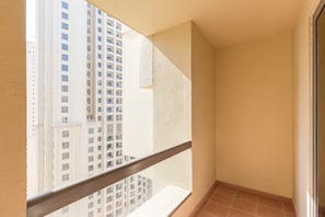 A narrow balcony with a view of high-rise buildings. - Spacious 1BR 5 minutes to beach (Dubai)