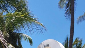 A stone staircase leading up to a white archway with a sign that reads "Aloha."