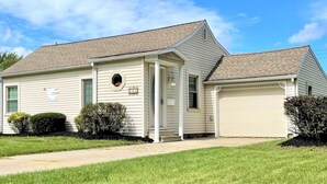 A single-story house with a garage, a small porch, and a well-maintained lawn. - North - Family Neighborhood, Pet Friendly (Paulding)