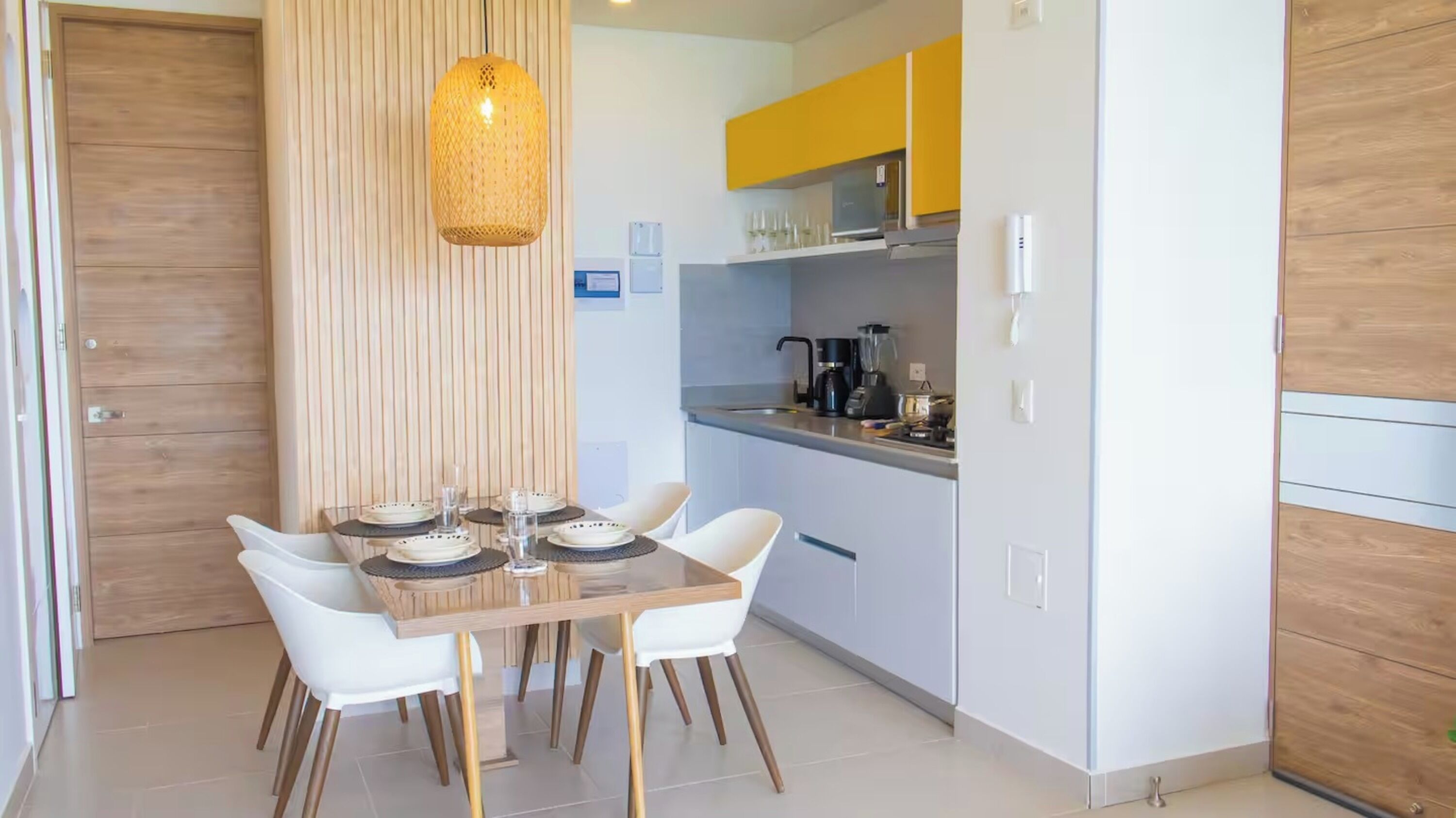 A modern kitchen with a dining area.