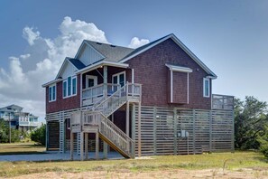A two-story house with a wooden deck and a staircase leading to the second floor. - Budget Modern 1 BRM/1 bath (Avon)