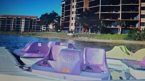 Um hotel com vários andares, varandas, piscina e área de praia.
