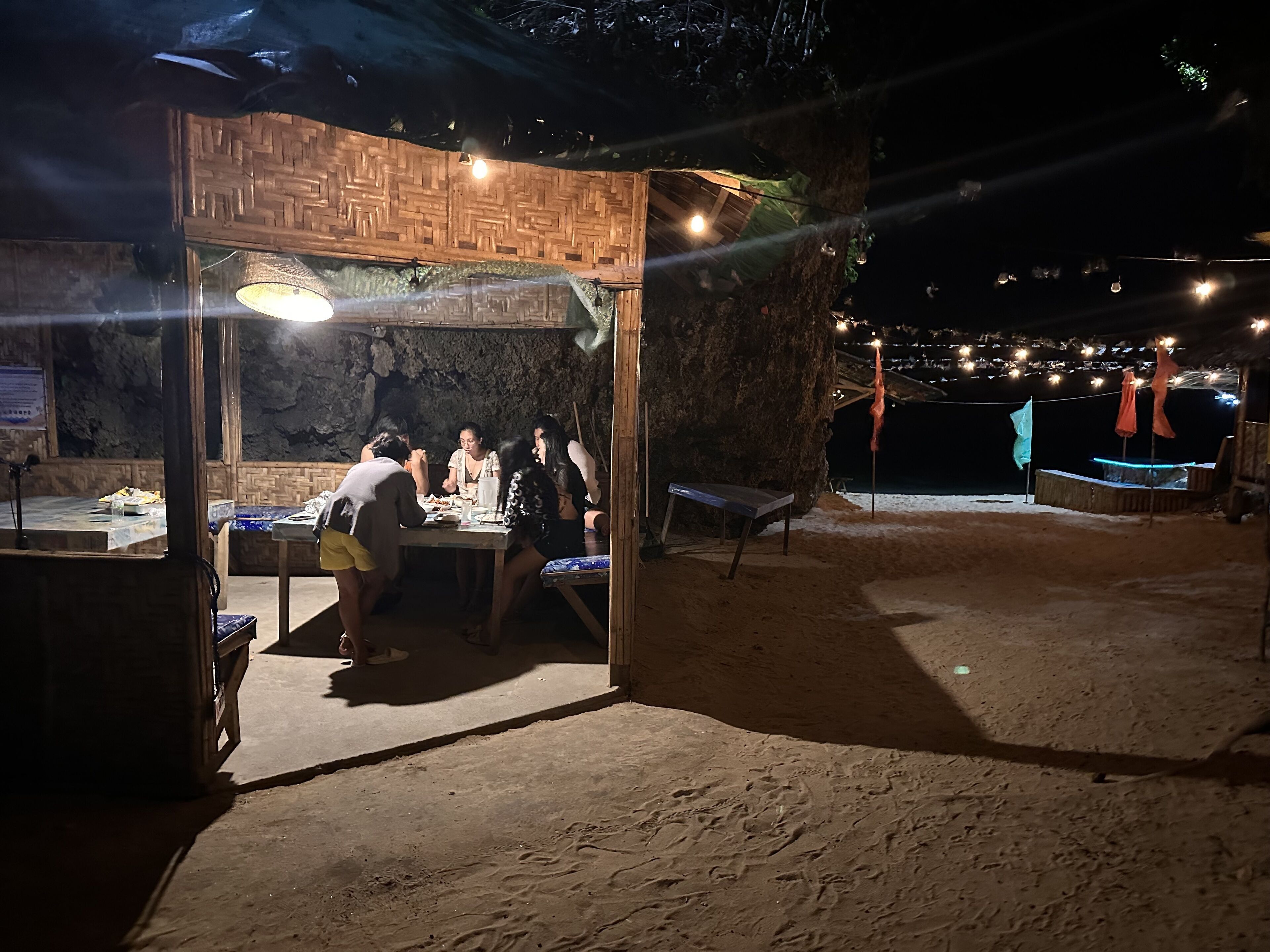 A dining area with a wooden structure, tables, and chairs.