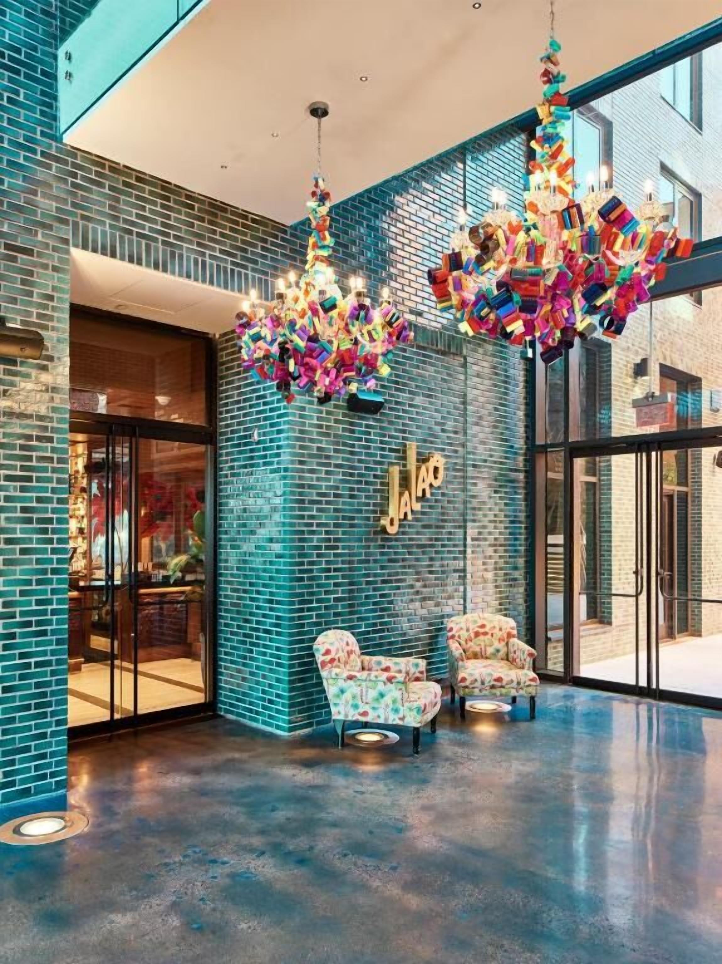 Step into a vibrant lobby with artful chandeliers and lounge seating.