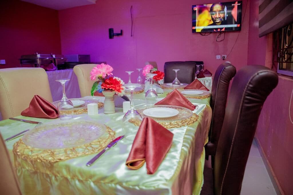 A dining area with a table set for four, including plates, cutlery, and napkins.