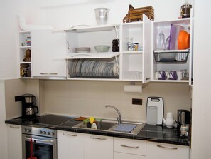 A kitchen with a stove, oven, sink, and various utensils. - 2 Bed Apartment Sleeps 4 with Free Parking (Durres)