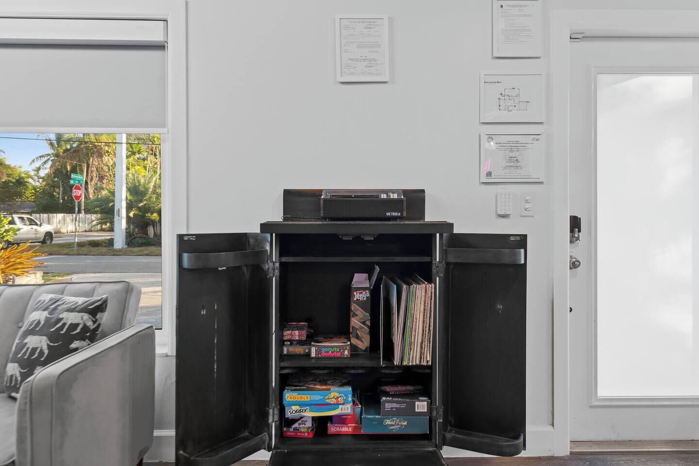 A compact room with a desk, a printer, and a door with a white frame.