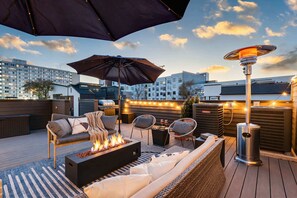 A rooftop patio with outdoor seating, a fire pit, and string lights. - Downtown Nashville family home, sleeps 10, 3 bedrooms, gourmet kitchen (Nashville)