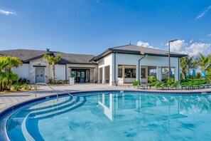 A modern building with a swimming pool, a covered outdoor area, and a restaurant. - Super Luxury Modern Home Prime Location (Kissimmee)