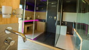 A modern bathroom with a glass shower enclosure, a wooden vanity, and a toilet. - Alpenchalet 341 by Interhome (Klippitztörl)