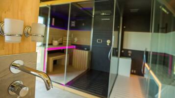Contemporary bathroom with a sink, glass shower, and wooden vanity.