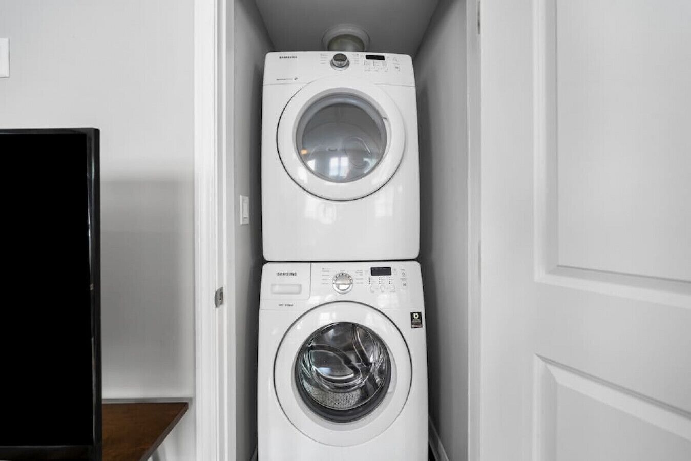 A laundry room with two stacked front-loading washing machines.
