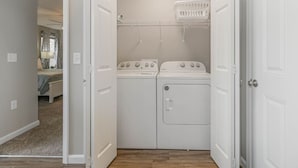 A laundry room with two washing machines and a drying rack. - BRAND NEW Home away from Home among the Nook (Hamilton)