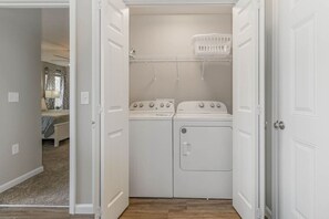 A laundry room with two washing machines and a drying rack. - BRAND NEW Home away from Home among the Nook (Hamilton)