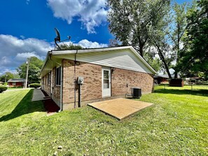 A small brick building with a flat roof, a door, and a small porch area. - Remodeled 2 BDRM Ranch Attached Home Liberty, TWP (Liberty Township)