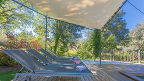 A wooden deck with lounge chairs and a canopy. - Mon Gîte en Provence - Fantastic Villa with Pool, Grand Piano and Fireplace in the Green Provence (Salernes)