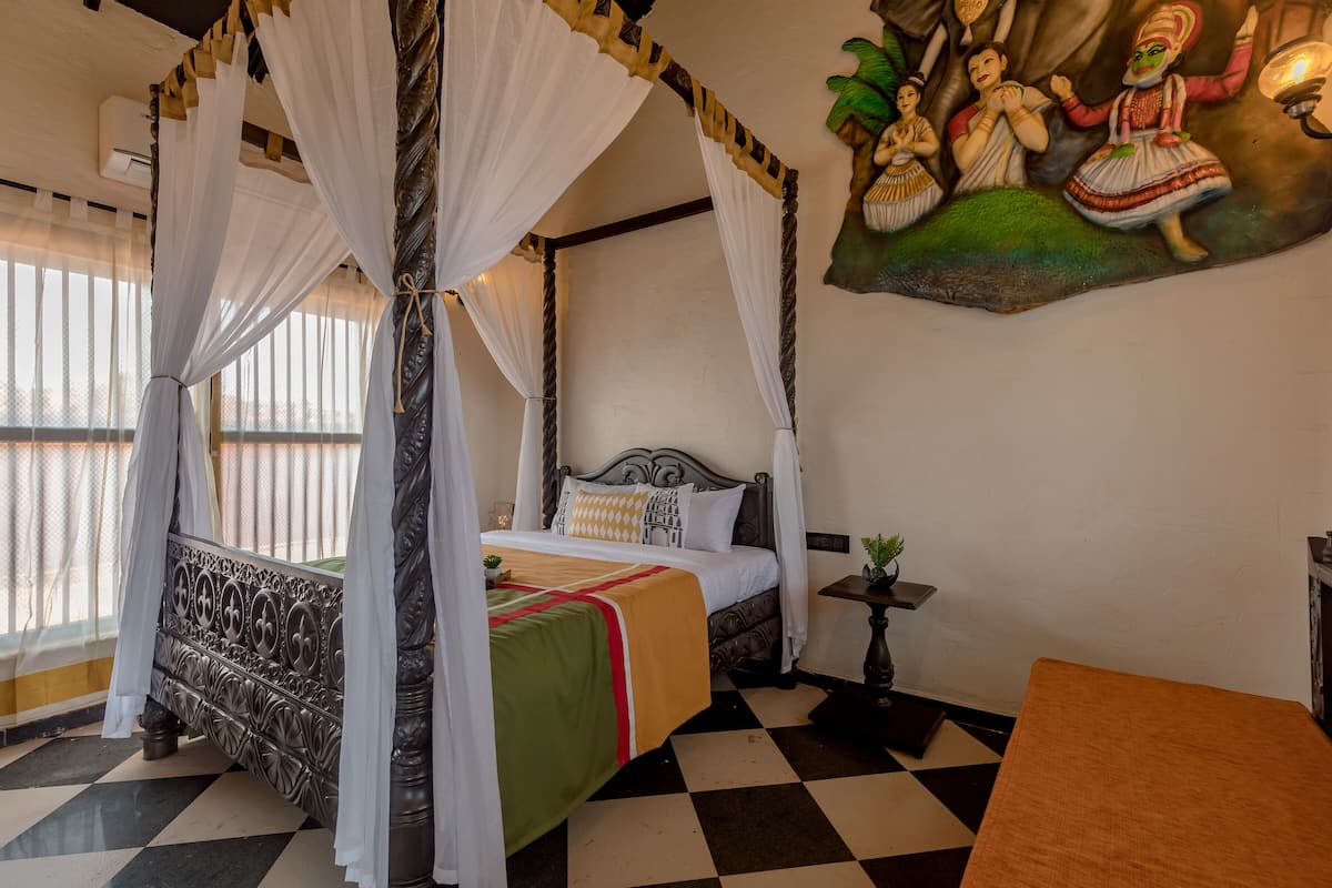 A four-poster bed with a canopy, a checkered floor, and a painting on the wall.