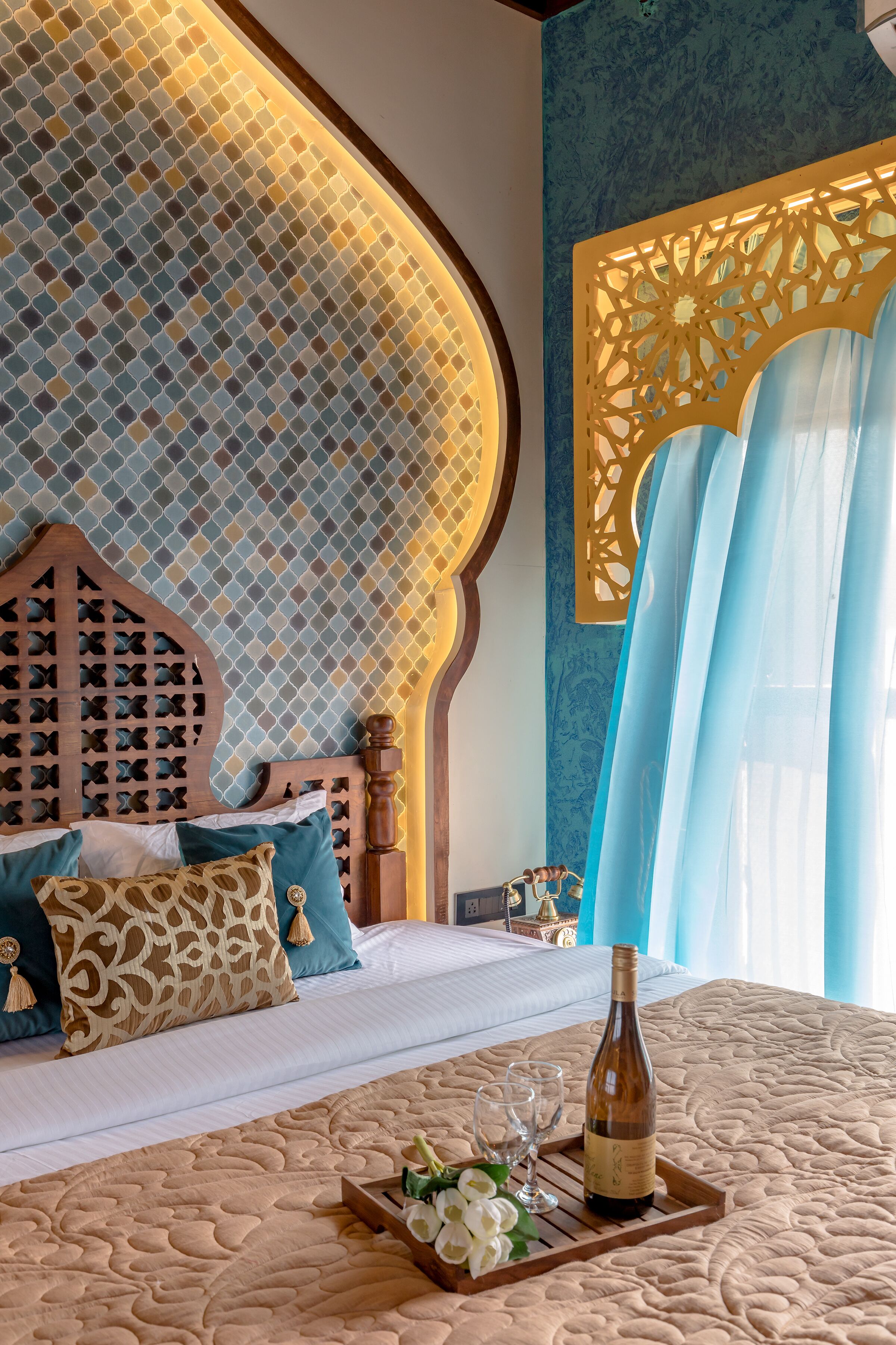 A bedroom with a patterned wall, a wooden headboard, and a bed with white bedding.